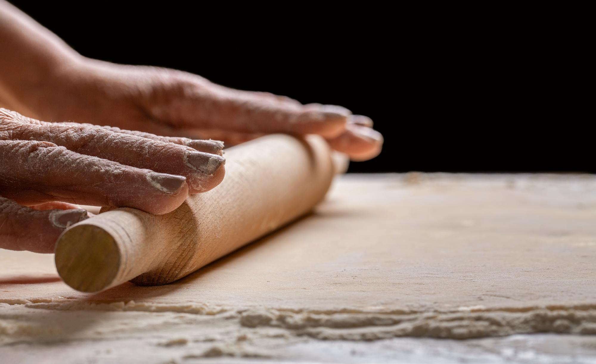 Close-up of hand rolling dough